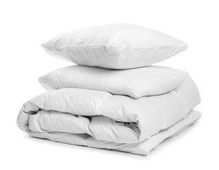 Fototapeta na wymiar Clean blanket and pillows on white background