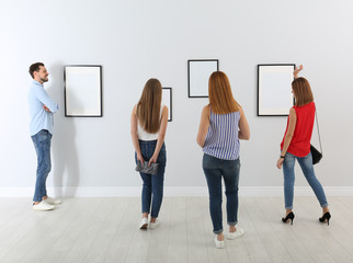 Naklejka premium People viewing exposition in modern art gallery