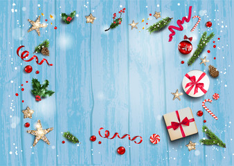 Holiday card with festive card and decorations balls, stars, snowflakes on blue wood background. Christmas festive template.
