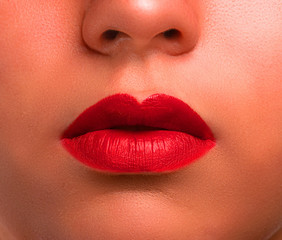 Unidentifiable woman, lips closeup macro, showing detailed mouth and red lipstick glamour studio shot