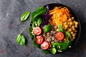 Acrylic prints meal dishes Healthy vegetarian dish with buckwheat and vegetable salad of chickpea, kale, carrot, fresh tomatoes, spinach leaves and pine nuts. Buddha bowl. Balanced food. Delicious detox diet.Top view