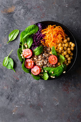 Healthy vegetarian dish with buckwheat and vegetable salad of chickpea, kale, carrot, fresh...