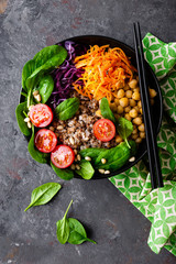 Healthy vegetarian dish with buckwheat and vegetable salad of chickpea, kale, carrot, fresh...