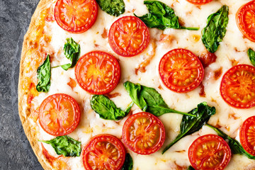 Pizza Margherita with mozzarella cheese, basil and tomatoes Traditional italian food. Classic recipe. Top view
