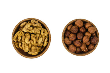 Wooden bowl with hazelnuts and wallnuts isolated on white background. The view from the top.