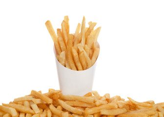 White cup full of french fries with french fries below on table isolated on white background. French fries have been popularized worldwide in large part by the large American fast food chains.