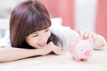 Happy woman with piggy bank