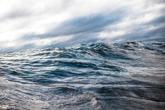 Fototapeta Winter sailing. Cold blue sea at sunset. waves and clouds, Norway