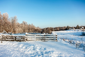 Fototapeta na wymiar winter rural landscape with frozen trees and fence