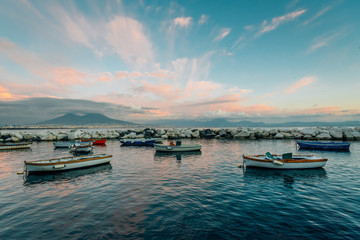 Fototapeta premium Boats and Mount Vesuvius at sunset, in Naples, Italy