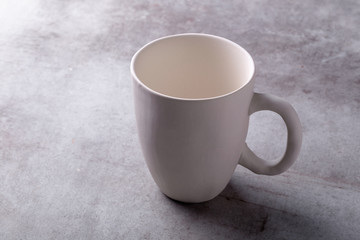 Empty blank white ceramic cup on Cement Board