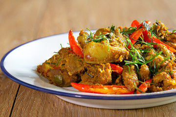 Stir fried cartilage pork with spicy curry paste (Thai call *Kua Kling*) thai food, in white dish