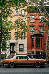 Fototapeta na wymiar Vintage car and houses in Greenpoint, Brooklyn, New York City
