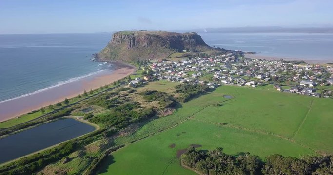 Aerial flight over Stanley with huge rock in background in Tasmania, Australia
