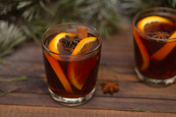 Christmas mulled red wine with spices on a wooden rustic table. Traditional hot drink at Christmas time