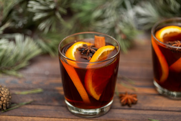 Christmas mulled red wine with spices on a wooden rustic table. Traditional hot drink at Christmas time