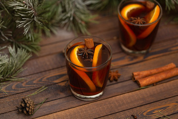 Christmas mulled red wine with spices on a wooden rustic table. Traditional hot drink at Christmas...