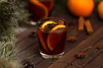 Christmas mulled red wine with spices on a wooden rustic table. Traditional hot drink at Christmas time