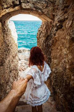 Couple walking down a narrow rocky staircase