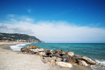 Fototapeta na wymiar Beautiful scenic view on coast and blue sea texture in foreground.