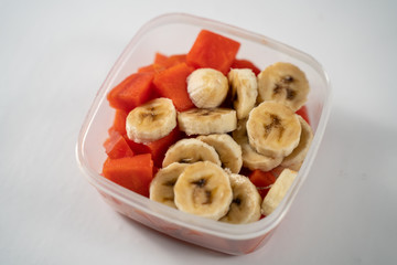Fruits in a bowl on a white background.