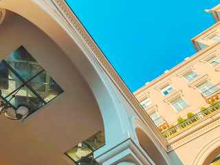 Facade of a building with columns against the sky. Bottom to top image