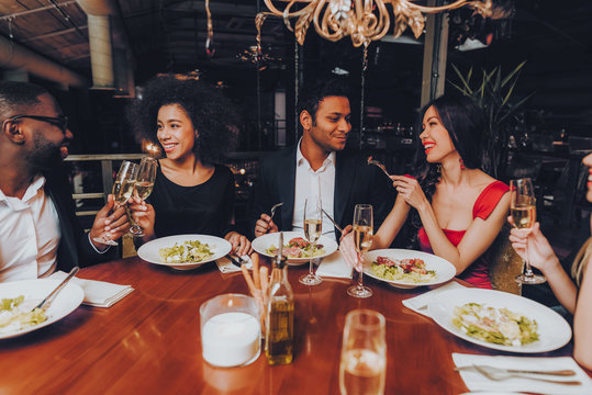 Friends Chilling Out Enjoying Meal In Restaurant