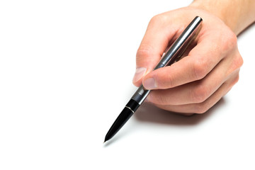 Men's hand holding  metal fountain pen on isolated backgroung, close up