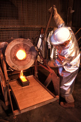 Gold mine worker pours molten Gold