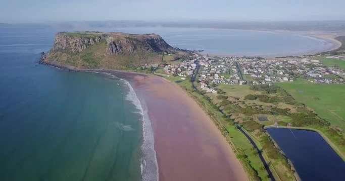 Ascending aerial flight over Stanley towards a huge rock in Tasmania, Australia