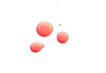 Living coral nail polish drops isolated on white background. Color of the year 2019 concept.