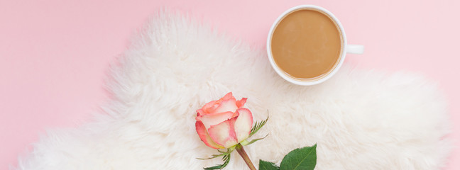 Cup of coffee and rose flower on pink background