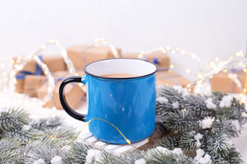 Obraz na płótnie Canvas Blue mug with hot tea, coffee or cocoa on winter holidays background