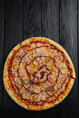 pizza barbecue sauce with chicken on black wooden background top view