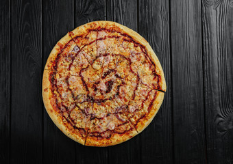 pizza barbecue sauce with chicken on black wooden background top view