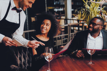 African American Couple Making Order in Restaurant