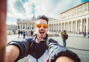 Happy tourist taking a selfie at Vatican city in Rome, Italy