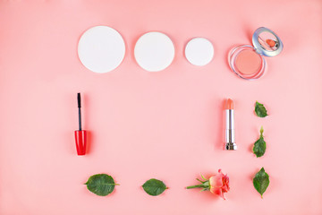 Naklejka premium Flat lay composition with lipstick, mascara, flowers.
