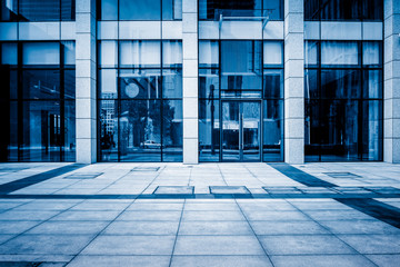 empty pavement front of the modern office entrance.