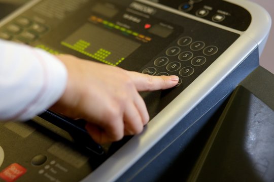 Close up of a touch pad technology on a cross trainer in a gym