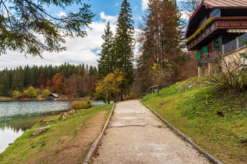 Autumn sunrise on the lower lake of Fusine. Explosion of colors