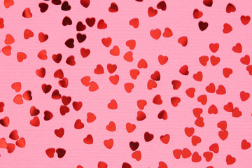Pink background with red confetti hearts for Valentine Day	