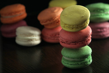 Bright macaroons against dark background