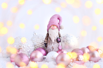 Christmas composition with gnome and festive decorations through the lights. New Year greeting card.