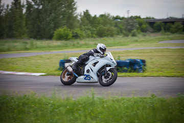 Fototapeta na wymiar Moto-athlete on the racetrack.