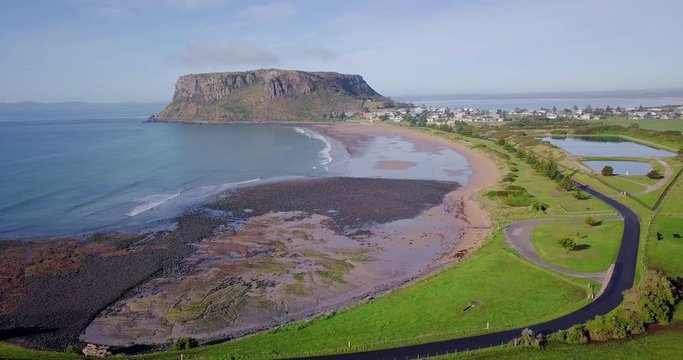 Aerial flight over rocky beach in Stanley towards rock in Tasmania, Australia