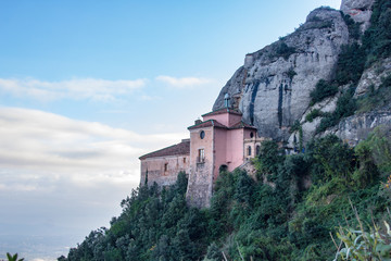 Fototapeta na wymiar Santa Cova Chapel on the cliff of Monterrat Abbey mountain, near Barcelona, Spain