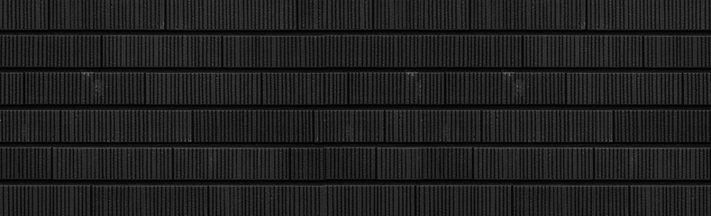 Fototapeta premium Panorama of Modern black stone tile wall pattern and background