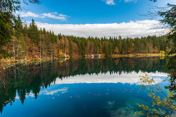 Autumn sunrise on the lower lake of Fusine. Explosion of colors