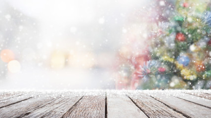 Empty wood table top on blur with bokeh Christmas tree background with snowfall - can be used for...